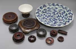 A Chinese underglaze blue and copper red dish, a bowl and various wood stands