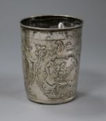 An 18th century? Russian repousse white metal beaker decorated with bird and foliage amid scrolls,