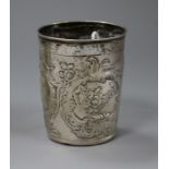 An 18th century? Russian repousse white metal beaker decorated with bird and foliage amid scrolls,