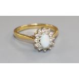 A modern 18ct gold, white opal and diamond cluster ring, size O.