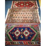 A Bokhara style mat and two others 116 x 66cm, 130 x 81cm and 125 x 65cm