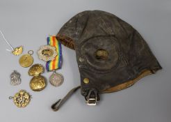 A military flying helmet, a 9ct gold and enamel Australian Commonwealth Military Forces brooch,