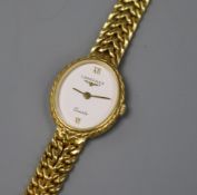 A lady's 9ct gold Longines quartz oval wrist watch, on a 9ct gold bracelet.