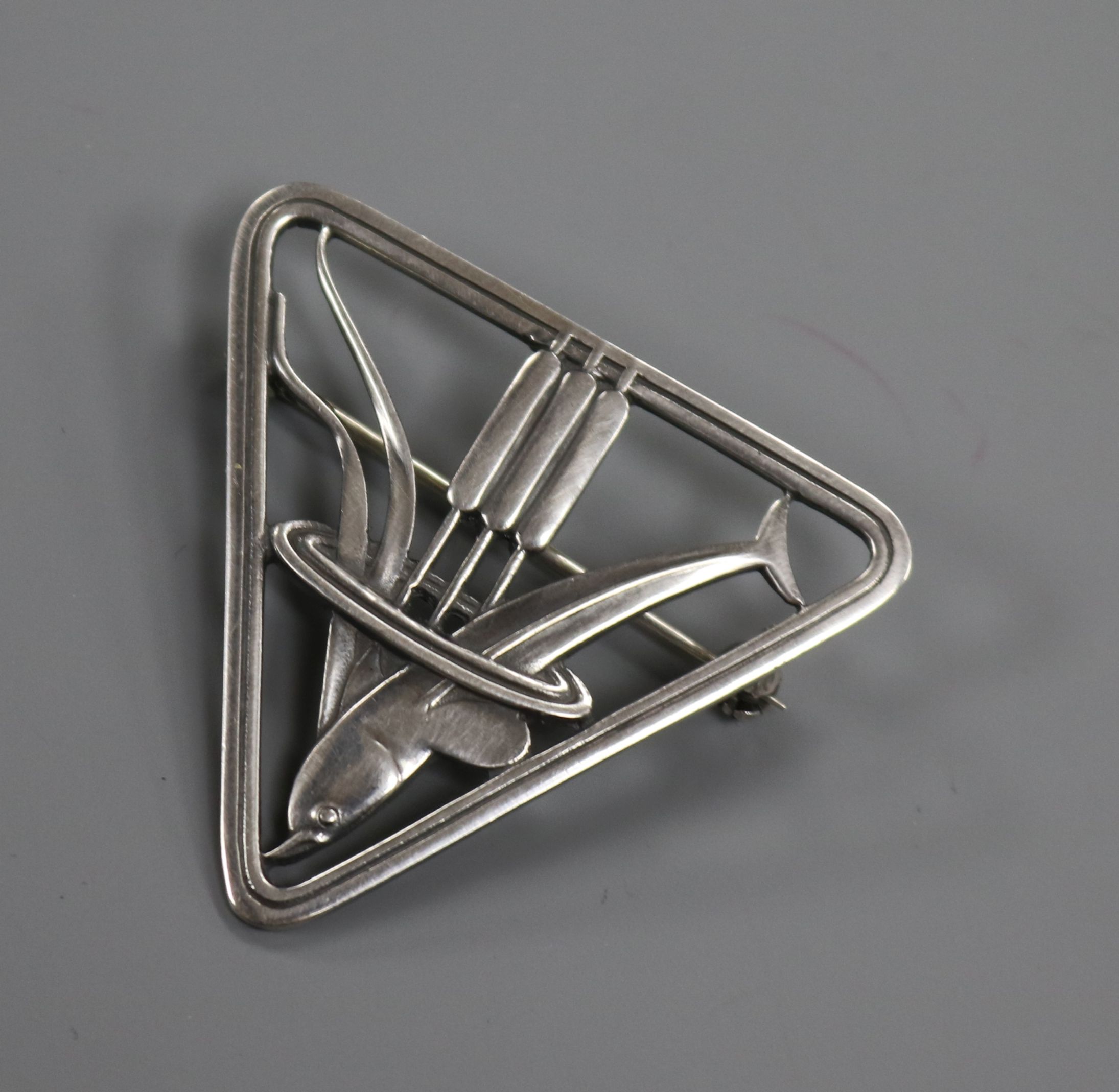 A Danish Georg Jensen sterling silver triangular dolphin brooch, no. 257, 37mm.