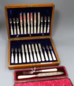 A cased set of twelve pairs of late Victorian silver dessert eaters and a cased knife and fork.