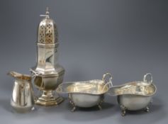 A silver octagonal baluster sugar caster, a pair of sauce boats with gadrooned edges and a cream