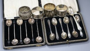 Two sets of six George V silver coffee spoons, three silver napkin rings, a Chinese napkin ring