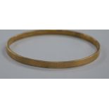 A 9ct gold plated metal core bangle.