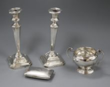 A pair of silver candlesticks, a silver two handled bowl and a late Victorian silver double hinged