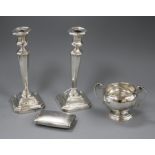 A pair of silver candlesticks, a silver two handled bowl and a late Victorian silver double hinged