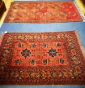 Two red ground rugs 190 x 107cm and 155 x 103cm