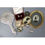 A silver-backed hand mirror, a Burmese pill box, silhouettes and sundries