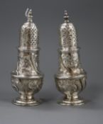 A pair of George II silver pepperettes, with later embossed decoration, Samuel Wood, London, 1748,