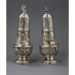 A pair of George II silver pepperettes, with later embossed decoration, Samuel Wood, London, 1748,