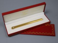 A gold plated Must de Cartier pen in box with certificate.
