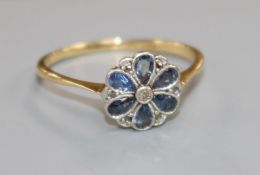 An 18ct gold and platinum, sapphire and diamond cluster flower head ring, size Q.
