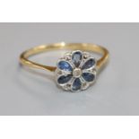 An 18ct gold and platinum, sapphire and diamond cluster flower head ring, size Q.