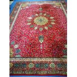 A Wilton Persian design red ground carpet 364 x 274cm