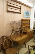 An Ercol six piece dining room suite consisting of four chairs, a drop leaf table, a sideboard and a