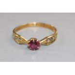 An early 20th century 18ct gold, single stone ruby ring, with diamond set shoulders, size K.