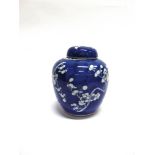 A LARGE CHINESE GINGER JAR AND COVER decorated with prunus blossom, 20.5cm high, four character mark