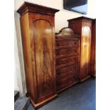 A VICTORIAN MAHOGANY BREAKFRONT COMPACTUM the central section of five long graduated drawers