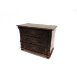 A CARVED OAK THREE DRAWER MINATURE CHEST 66cm wide 45cm deep 73cm high