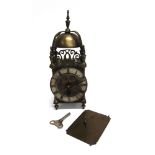 A 20TH CENTURY BRASS CASED LANTERN CLOCK of traditional form, with silvered chapter ring applied