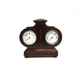 AN EDWARDIAN CLOCK/BAROMETER in an ornate inlaid mahogany case raised on four brass bun supports,