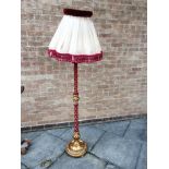 A FLOOR LAMP the column and base part gilt painted and part fabric covered, height 149cm
