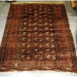 A RED GROUND RUG the central field with three rows of guls, 127cm x 145cm