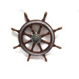 A TEAK SHIP'S WHEEL of eight spokes, overall 76cm diameter (inclusive of handles).