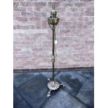 A BRASS PEDESTAL OIL LAMP on circular base, converted to a floor lamp, height 138cm