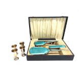 A SILVER AND ENAMEL FOUR PEICE DRESSING TABLE SET in a fitted case; with four small goblets