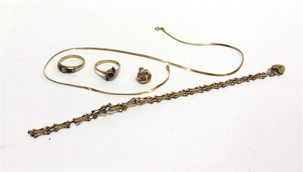 A 9 CARAT GOLD DRESS RING another 9 carat gold dress ring; a 9 carat chain with pendant; and a 9