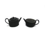 TWO VICTORIAN BASALT WARE TEAPOTS one impressed 'Wedgwood' with relief decoration of trailing
