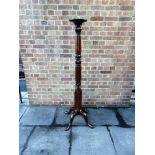 A TALL MAHOGANY TORCHIERE the carved and reeded column raised in four outswept cabriole supports,