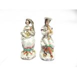 A PAIR OF VICTORIAN STAFORDSHIRE FIGURES of a highland couple playing musical instruments, 18cm