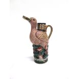 A FAMILLE ROSE FIGURAL VASE/JUG modelled as a bird standing amonsgst flowers, its beak as spout,