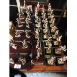 THIRTY-THREE CAST METAL SOLDIER FIGURINES some arranged in pairs, all set to plinth bases, all