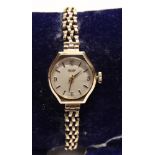 TISSOT, A LADY'S 9 CARAT GOLD MECHANICAL WRIST WATCH on a bracelet, 13g gross