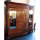 A LARGE VICTORIAN COMPACTUM the bow fronted central section with a pair of panelled doors