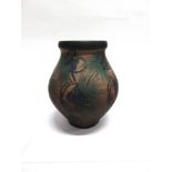 A LARGE DANISH ART POTTERY VASE decorated in blue and green floral motifs on a brown ground, incised