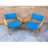 HANS WEGNER FOR GETAMA: a pair of oak framed armchairs, with blue fabric upholstered seats and