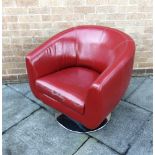 A RED UPHOLSTERED TUB ARMCHAIR on chrome circular spreading base