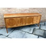 A NATHAN TEAK 'CIRCLES' SIDEBOARD, fitted with central two door cupboard, drop-down drinks