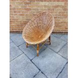 A CANE TUB CHAIR the oval seat 72cm wide, 90cm high overall