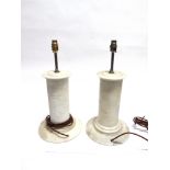 A NEAR PAIR OF TURNED MARBLE LAMP BASES one with textured decoration, 34.5cm high excluding