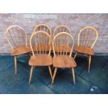 A SET OF SIX ERCOL STICKBACK DINING CHAIRS light elm and beech, stamped 'BS 1960 EF 2056' to