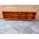 A PAIR OF TEAK OPEN BOOKCASES with adjustable shelves, on chrome pillar supports, 121cm wide 30cm